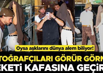 Dolu dizgin aşklarını hala herkesten saklamaya çalışıyorlar: Fotoğrafçıları görünce ceketini başına geçiriverdi